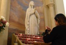 Una mujer reza el Rosario en Orlando, Florida